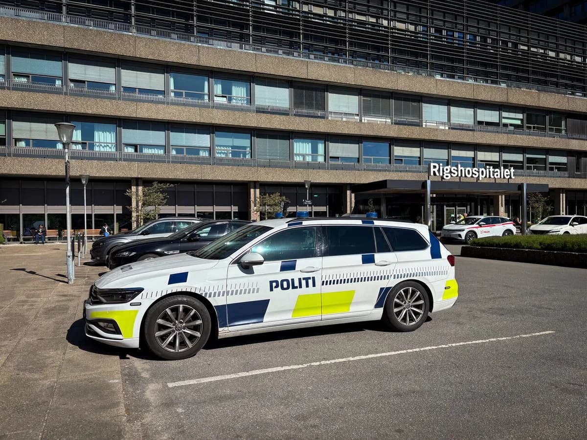 Danish police car parked outside Rigshospitalet hospital entrance in Copenhagen
