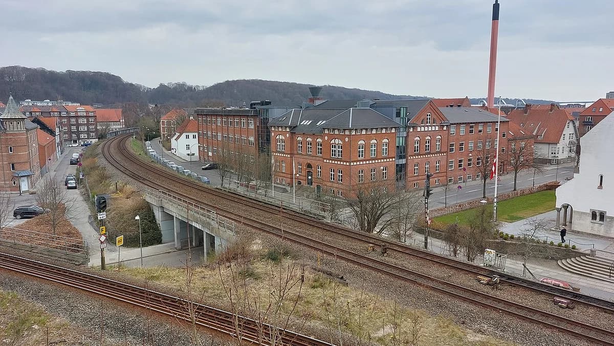 Elevated view of railway tracks and buildings in Vejle, Denmark.
