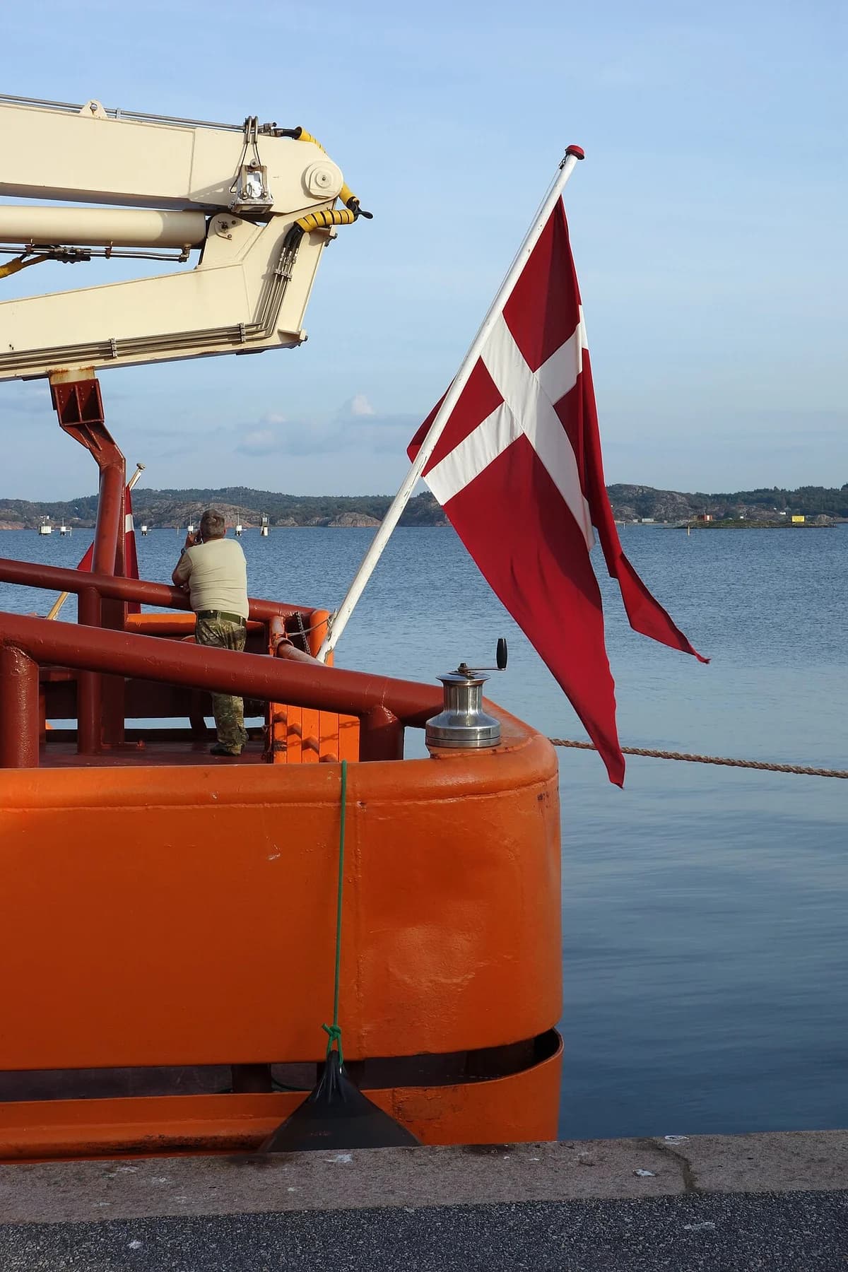 Danish flag on an orange ship at harbor