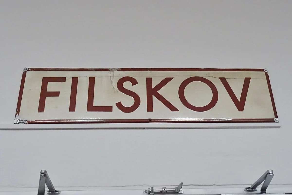 Filskov station sign displayed on a white wall